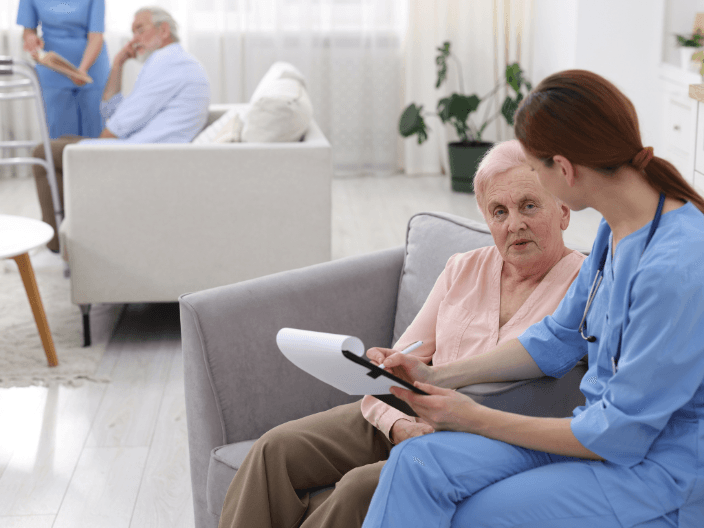 Carer speaking with elderly woman at home — effective communication techniques for aged care and disability support
